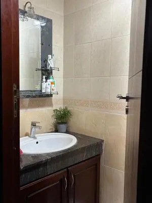 a bathroom with a sink and a mirror at The green stay in Rabat