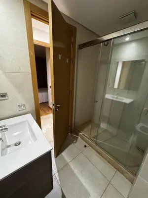 a bathroom with a glass shower and a sink at Murcia in Rabat