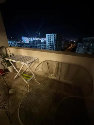 two chairs and a table on a balcony at night at Murcia in Rabat