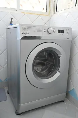 a washing machine in a bathroom with a window at Modern Luxury Apartment - Ground Floor in Rabat