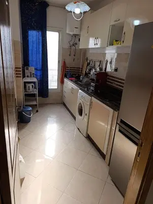 a kitchen with a washer and dryer in it at Carino Solare ben ordinato in Dar Ben Abdallah Ben Dehbi