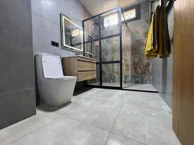a bathroom with a toilet and a sink at Appartement sur villa in Temara