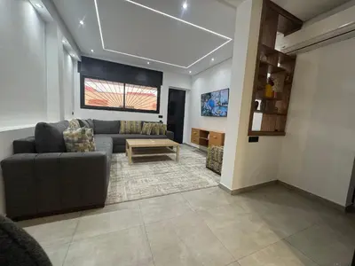 a living room with a couch and a table at Appartement sur villa in Temara