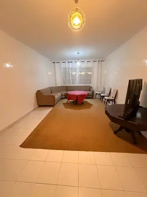 a living room with a couch and a table at Appartement avec vue sur monument emblématique Hassan II in Casablanca