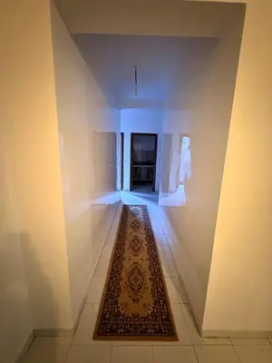 an empty hallway with a rug on the floor at Appartement avec vue sur monument emblématique Hassan II in Casablanca