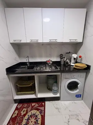 a kitchen with a sink and a washing machine at Appartement avec vue sur monument emblématique Hassan II in Casablanca