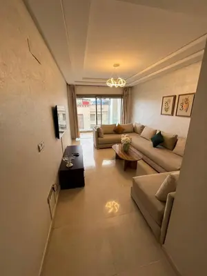 a living room with a couch and a table at Palm Pool View Apartment - Bouznika in Bouznika