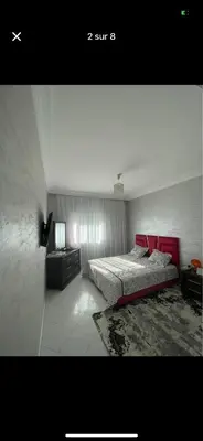 a bedroom with a bed with a red headboard at Amir 11 A in Casablanca