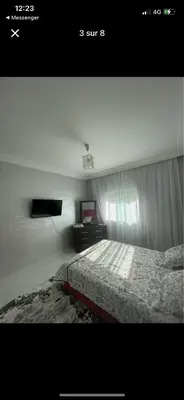 a bedroom with a bed and a window and a television at Amir 11 A in Casablanca