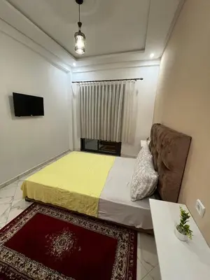a small room with a bed and a couch at Charming appartement next to the airport in Deroua