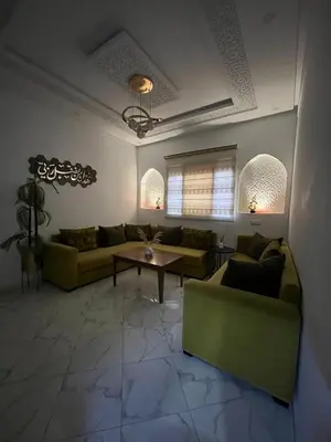 a living room with two couches and a coffee table at Charming appartement next to the airport in Deroua