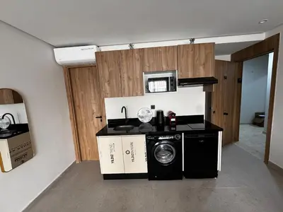 a kitchen with a washing machine and a microwave at Studio 14 in Casablanca
