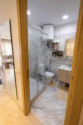 a bathroom with a shower and a toilet and a sink at Chic Cozy Studio Maarif Casablanca in Casablanca