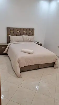 a bedroom with a large bed with a headboard at Appartement moderne Temara à 10 minutes de Rabat in Temara