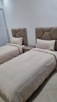 two beds sitting next to each other in a room at Appartement moderne Temara à 10 minutes de Rabat in Temara