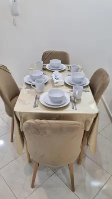 a table with plates and dishes on top of it at Appartement moderne Temara à 10 minutes de Rabat in Temara