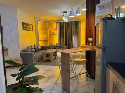 a kitchen and a living room with a refrigerator at Fatine