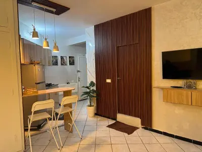 a kitchen with a table and chairs and a television at Fatine