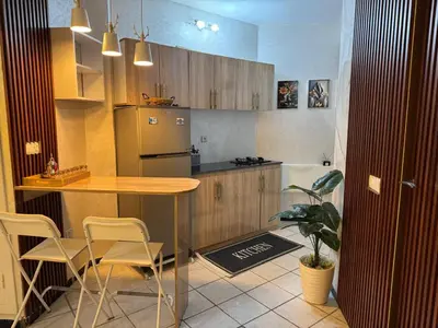 a kitchen with a table and chairs and a refrigerator at Fatine