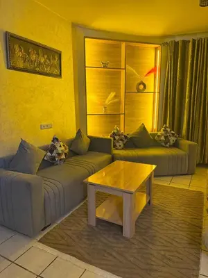 a living room with two couches and a coffee table at Fatine