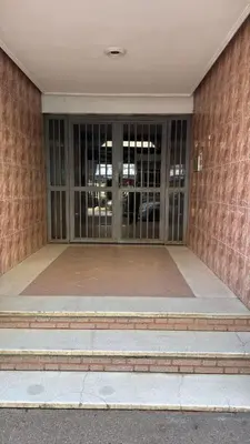 a building with glass doors and a brick wall at Fatine