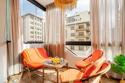 a room with chairs and a table and a window at Appart luxeux à zenata piscine , plage à 3 min in Aïn Harrouda