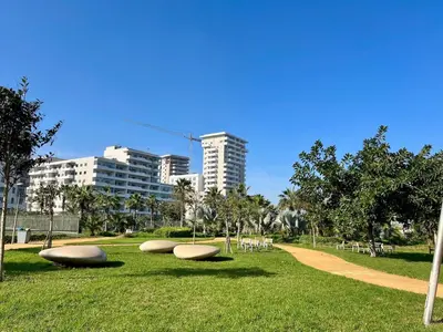 a park with three objects laying on the grass at Appart luxeux à zenata piscine , plage à 3 min in Aïn Harrouda