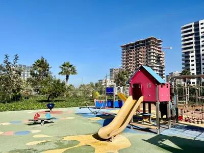 a playground with a slide and a play structure at Appart luxeux à zenata piscine , plage à 3 min in Aïn Harrouda