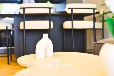 a table with a white vase sitting on top of it at Hamma - 1 BR - Premium condo in Casablanca