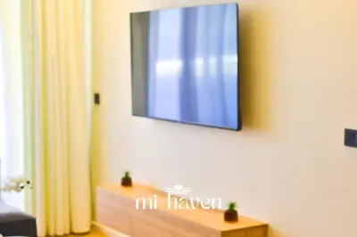 a flat screen tv hanging on a wall at Hamma - 1 BR - Premium condo in Casablanca
