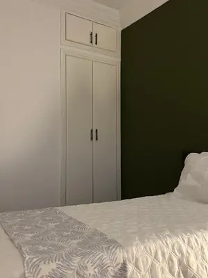 a bedroom with a white cabinet and a bed at The Green homestay in Rabat