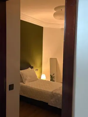 a bedroom with a bed and a mirror at The Green homestay in Rabat