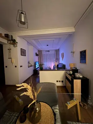 a living room with a couch and a table at The Green homestay in Rabat
