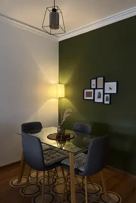 a dining room with a table and blue chairs at The Green homestay in Rabat