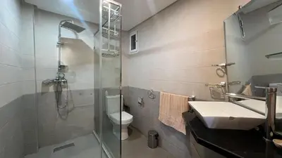 a bathroom with a shower and a toilet and a sink at Apartment with impressive sea view! in Rabat