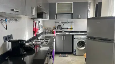 a kitchen with a washer and a washing machine at Apartment with impressive sea view! in Rabat