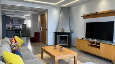 a living room with a couch and a flat screen tv at Apartment with impressive sea view! in Rabat