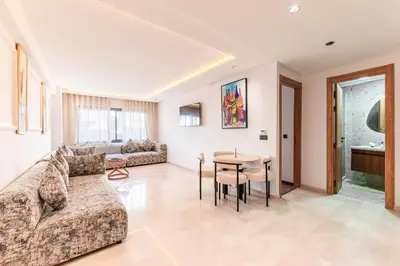 a living room with a couch and a table at L'osmo - 1 BR - 2m from CFC in Casablanca