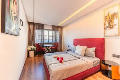 a bedroom with a bed with a teddy bear on it at L'osmo - 1 BR - 2m from CFC in Casablanca