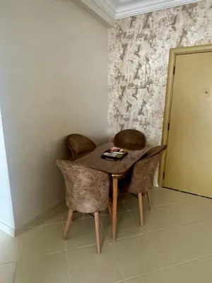 a wooden table and chairs in a room at Appartement lumineux a belvedere in Casablanca