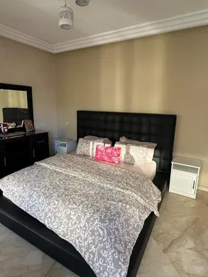 a bedroom with a large bed with two pink pillows at Casablanca ANFA Apartment in Casablanca