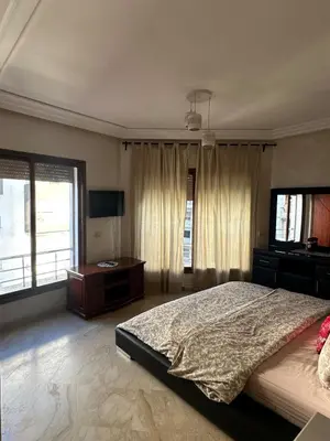 a bedroom with a large bed and a television at Casablanca ANFA Apartment in Casablanca