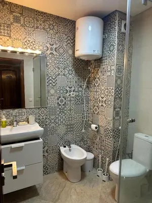 a bathroom with a sink and a toilet and a mirror at Casablanca ANFA Apartment in Casablanca