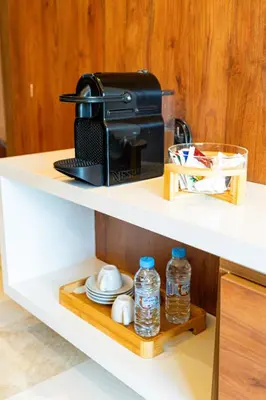a coffee maker and water bottles on a shelf at Suite Cosy Moderne Chic Calme Jardin and Habous in Casablanca