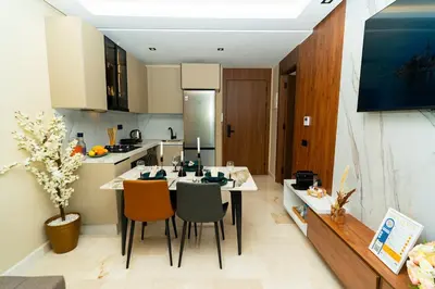 a kitchen with a table and chairs in a room at Suite Cosy Moderne Chic Calme Jardin and Habous in Casablanca