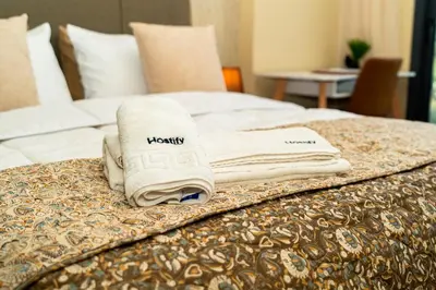 a pile of towels sitting on top of a bed at Suite Cosy Moderne Chic Calme Jardin and Habous in Casablanca