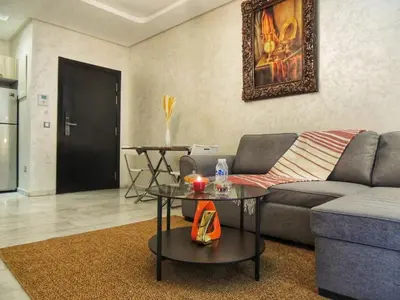 a living room with a couch and a table at Appart de luxe, Confort et Emplacement, Corniche STAY MEMORIES in Mohammedia