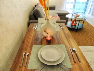 a table with a plate and a vase on it at Appart de luxe, Confort et Emplacement, Corniche STAY MEMORIES in Mohammedia