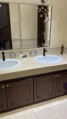 a bathroom with two sinks and a large mirror at Big Villa In Rabat in Rabat
