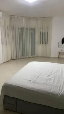 a large white bed in a room with windows at Big Villa In Rabat in Rabat